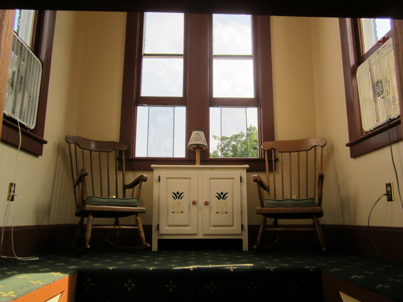 Chairs and stand in front of a window